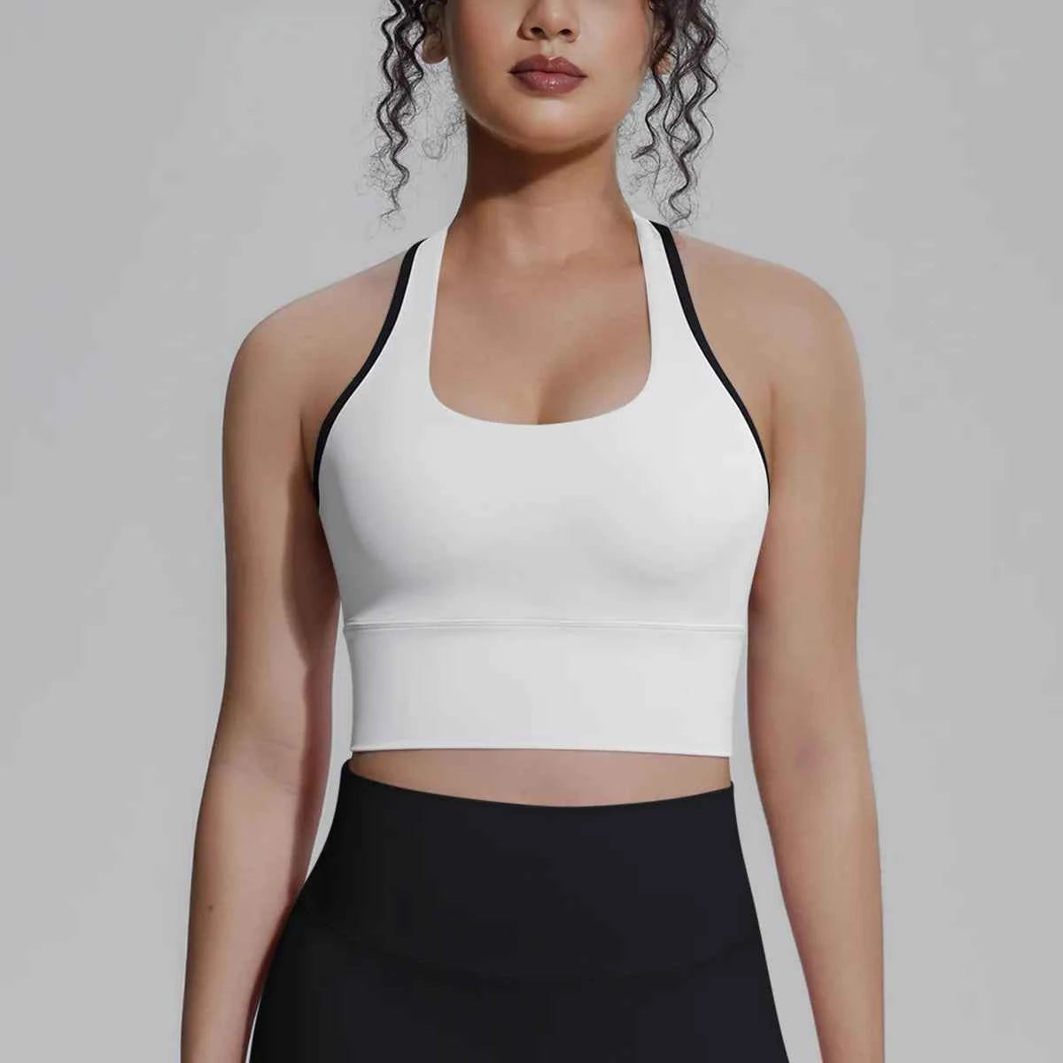 White women's sports top from Corporación Turística, designed for fitness, running, and training activities.