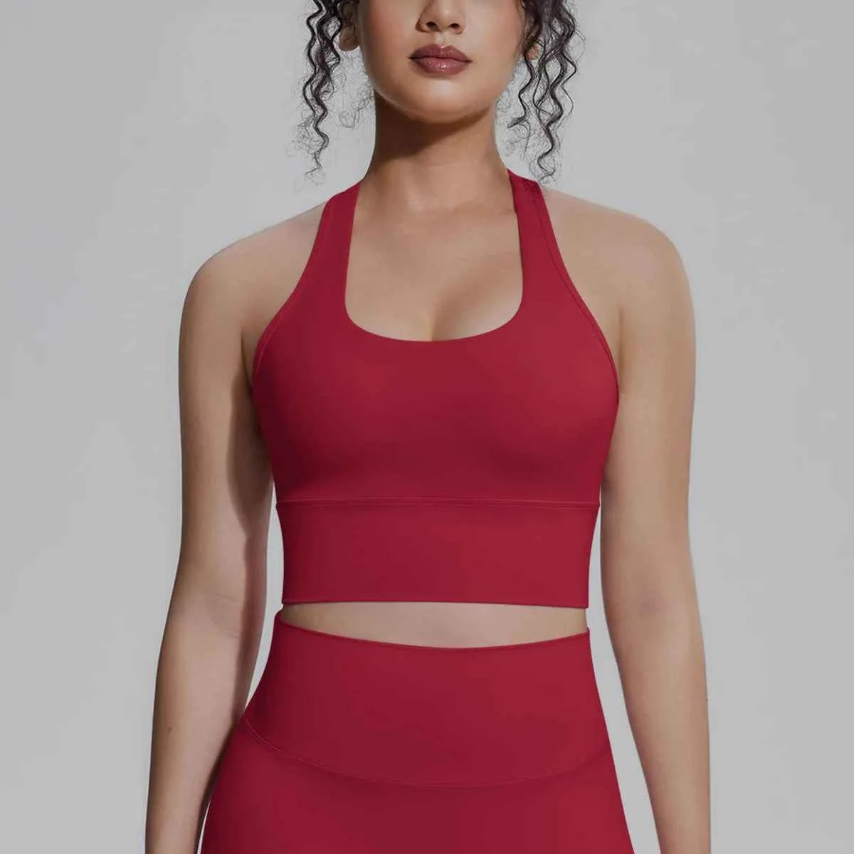 White women's sports top for fitness and running, made by Corporación Turística, with a sleek, athletic design suitable for workouts.