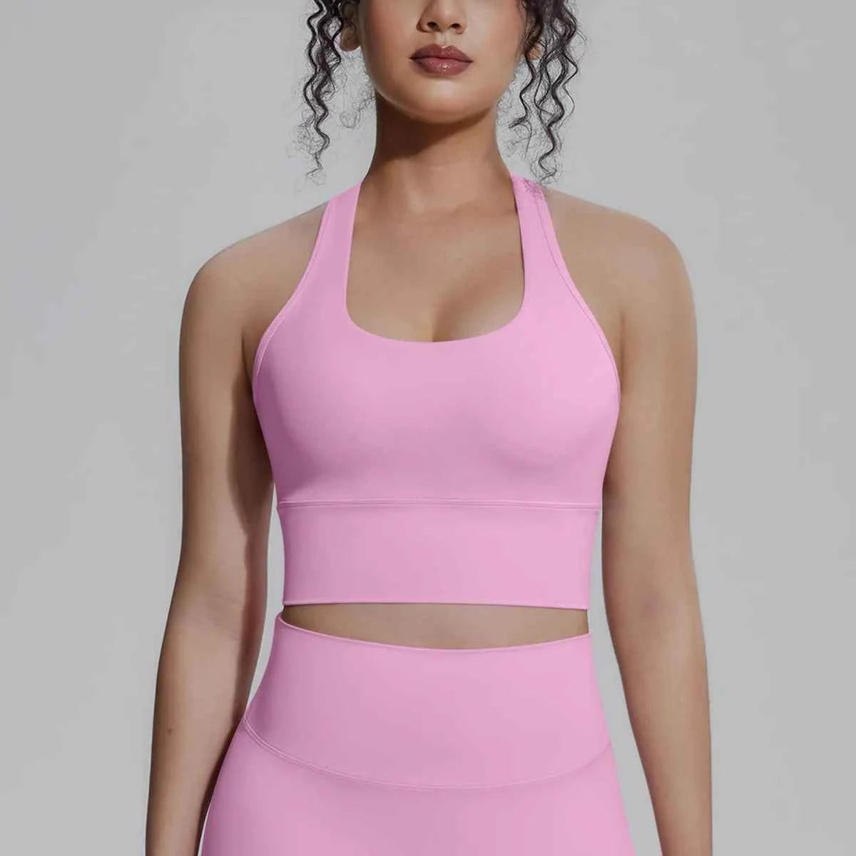 White women's sports top by Corporación Turística, designed for fitness and running, featuring a comfortable fit and breathable fabric.