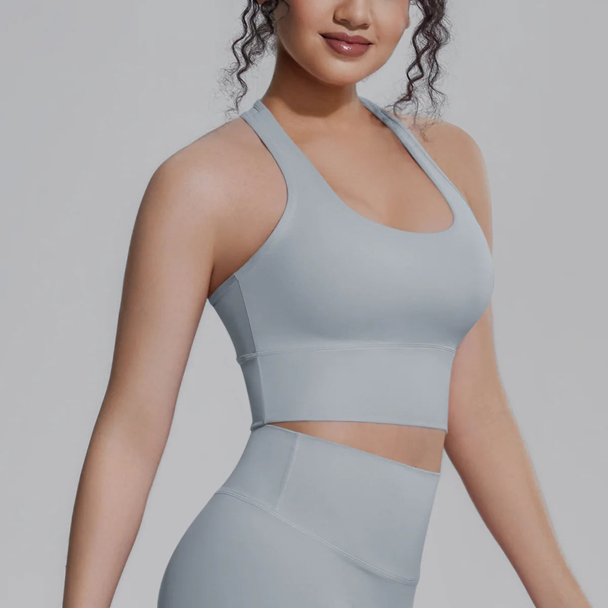 White women's sports top from Corporación Turística, ideal for fitness, running, and training activities.