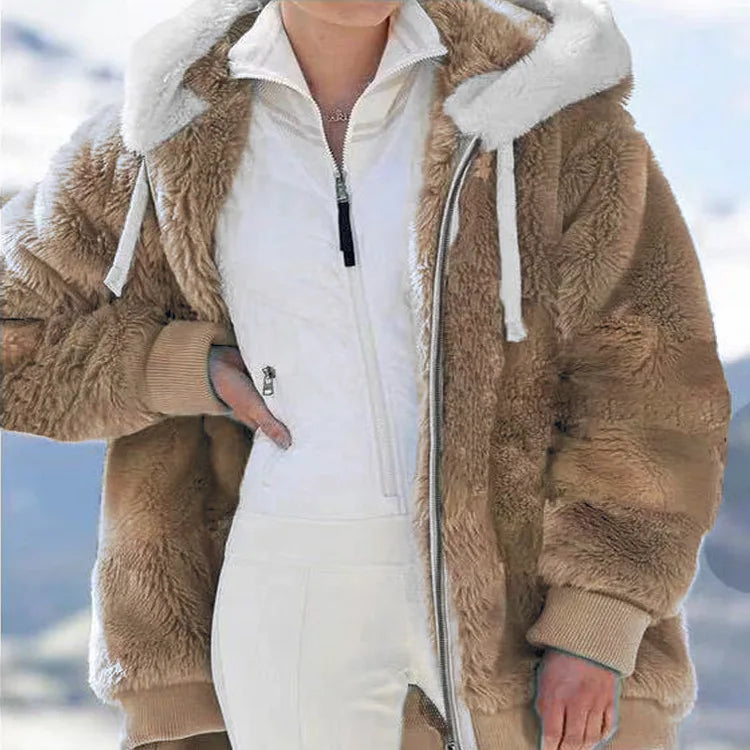 White women's oversized fleece zip-up coat by Corporación Turística, showing the relaxed fit and cozy fabric.
