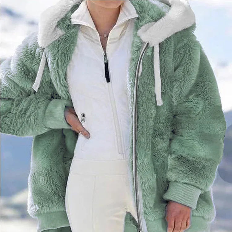 White women's oversized fleece zip-up jacket by Corporación Turística, showing the cozy, relaxed fit and front zipper details.