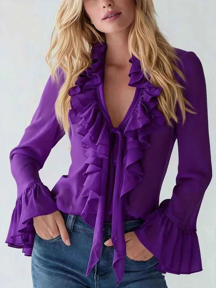 White women's blouse with ruffled details, tie cords, and long flared sleeves by Corporación Turística.