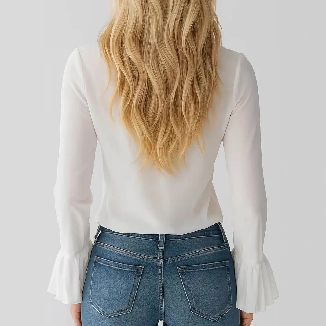 White women's blouse with ruffled details, long flared sleeves, and corded accents from Corporación Turística.