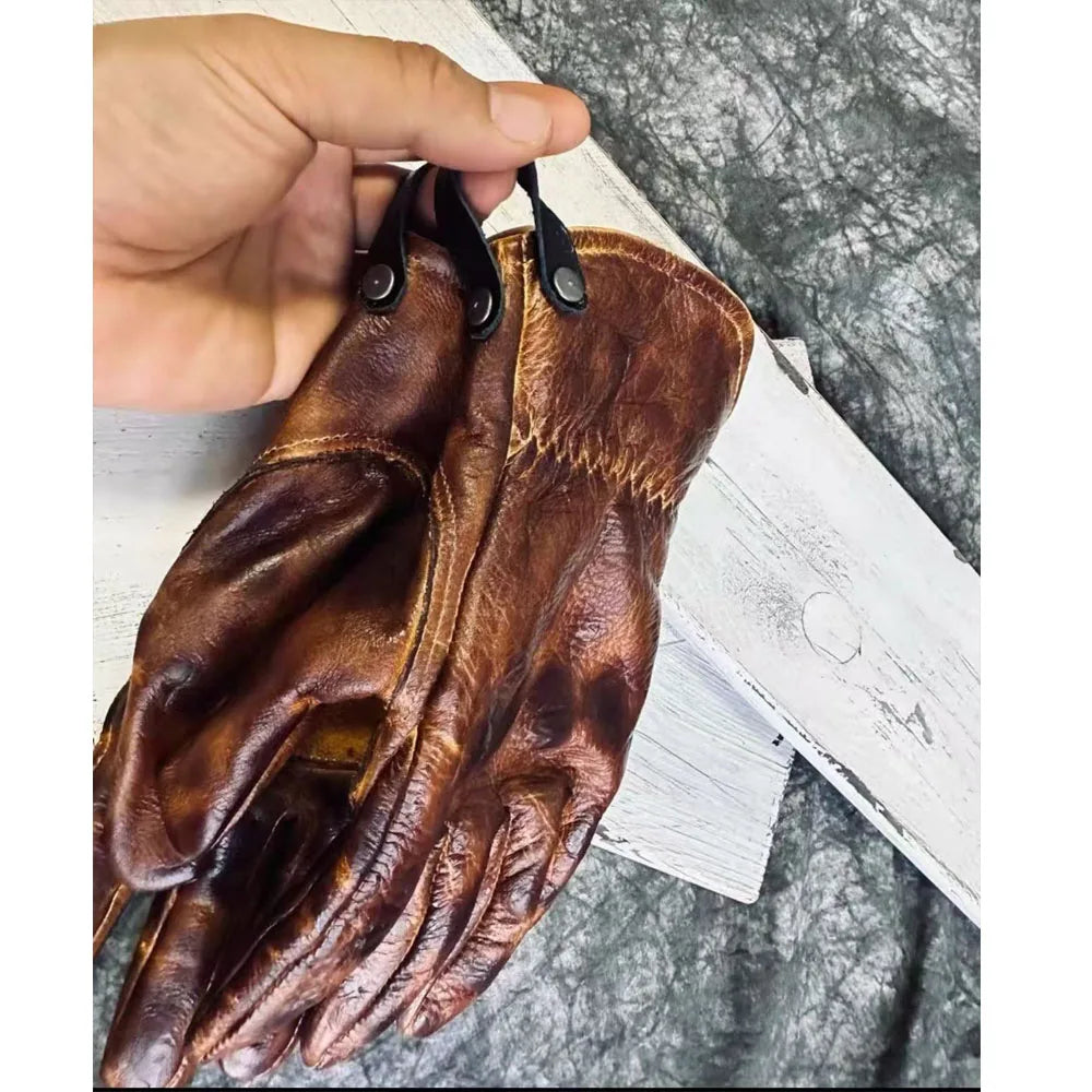Summer and winter motorcycle gloves in amber color, made by Corporación Turística, showing the gloves laid out on a neutral background.
