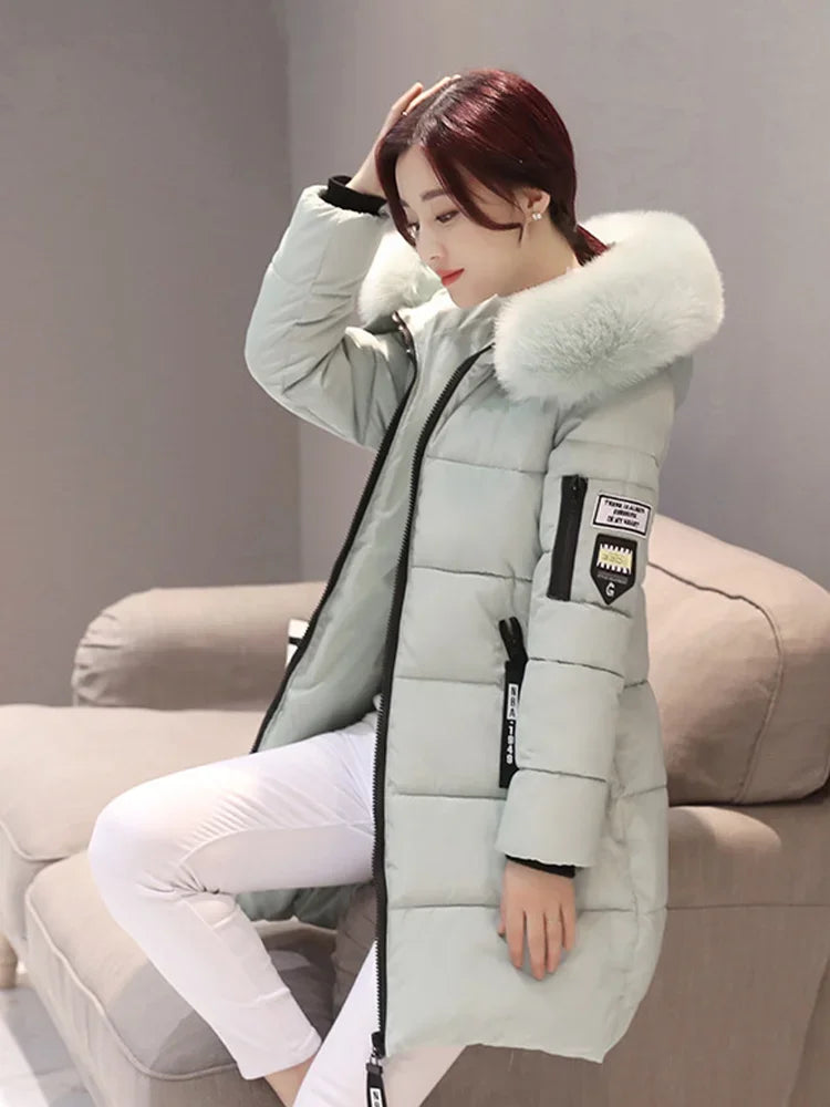Black women's long winter coat with hood and high collar, featuring a stylish and warm design from Corporación Turística.