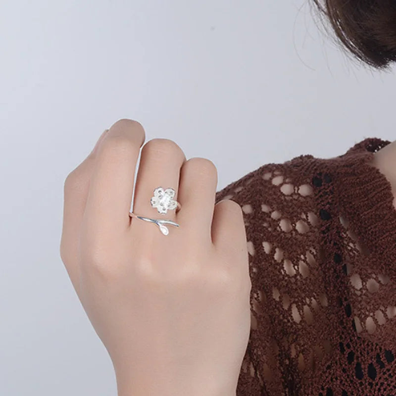 Sterling silver 925 ring with floral design and sparkling cubic zirconia, showcasing delicate flower details and high-quality craftsmanship.