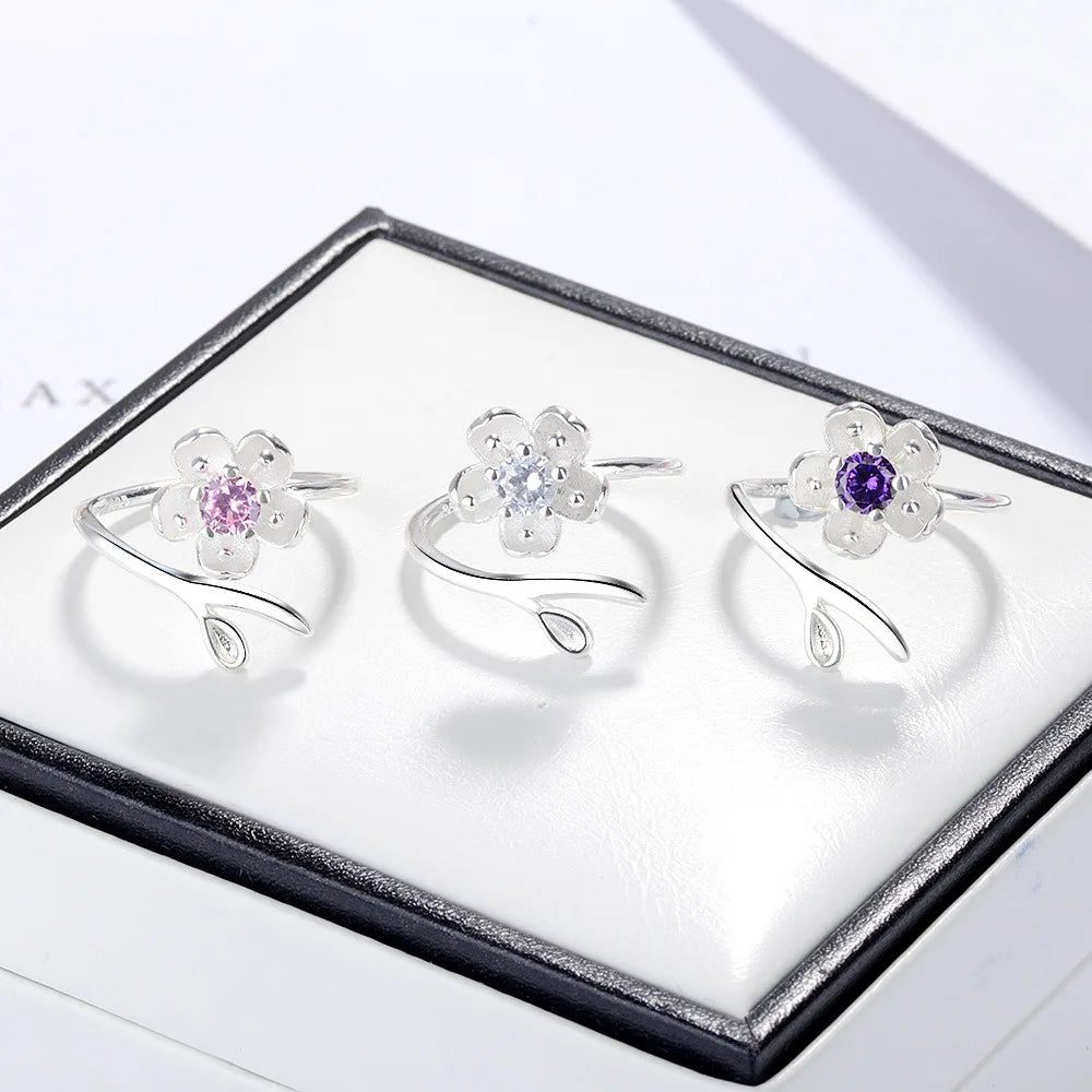Sterling silver 925 ring with floral design and high-quality cubic zirconia, showcasing intricate flower details and sparkling stones.