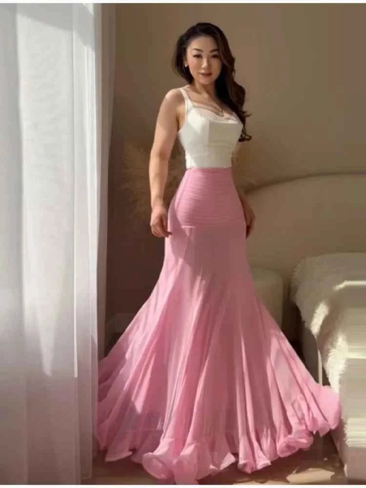 Elegant white maxi mermaid skirt with polka dots and ruffles by HOLD YOUNG, perfect for a sophisticated summer look.