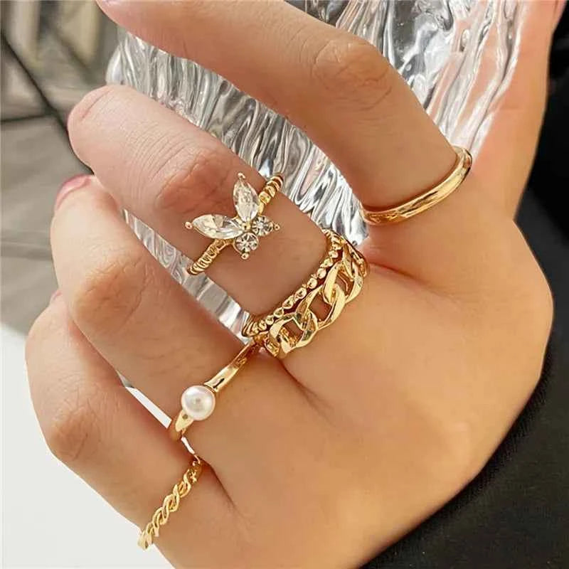 Set of bohemian Modyle 18K gold wedding rings with circon stones, featuring multiple interconnected rings for women.