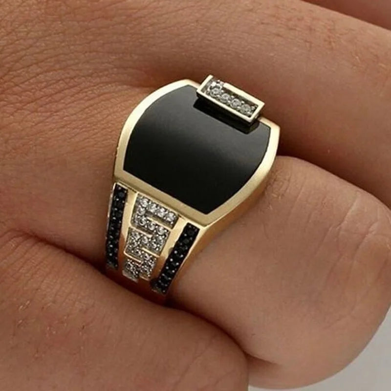 Gold men's punk ring with black stone and cubic zirconia, ideal for wedding or engagement jewelry.