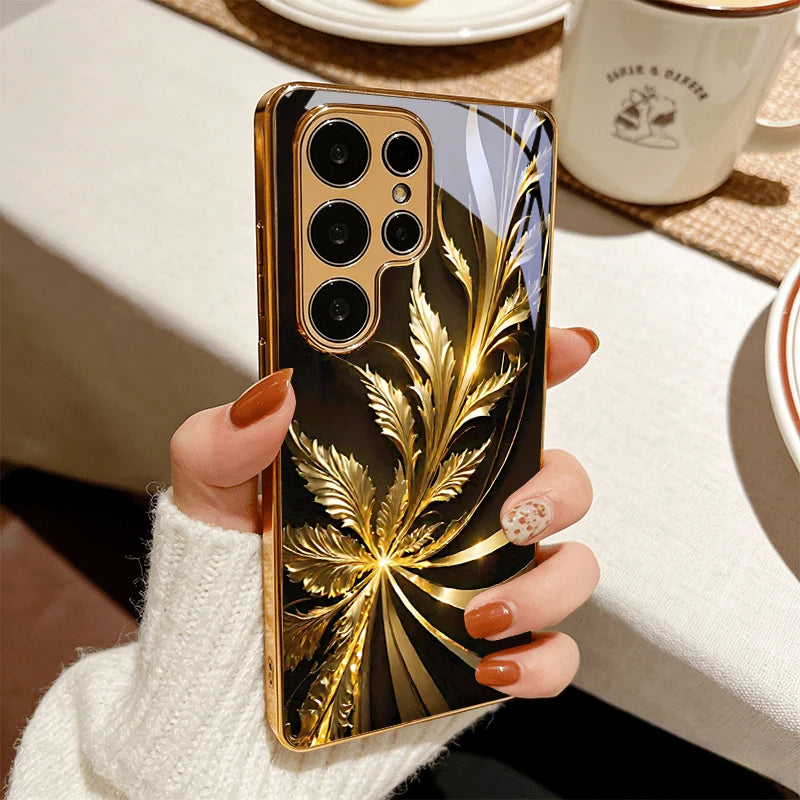 Gold phone case with radiant foliage design, featuring intricate leaf patterns and a stylish, decorative look.