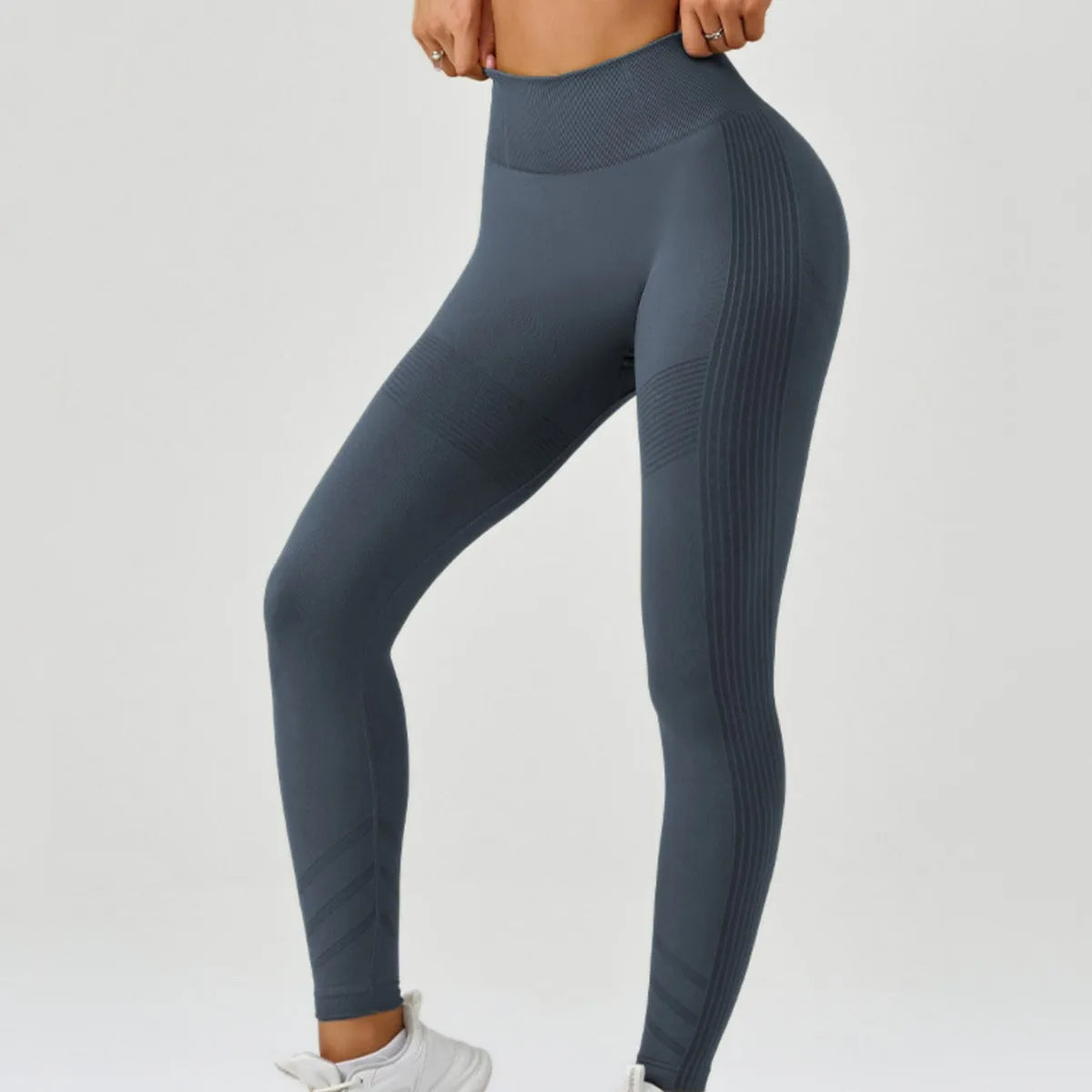 High-waisted women's yoga leggings from Corporación Turística, made of seamless stretchy fabric, shown in a close-up image.