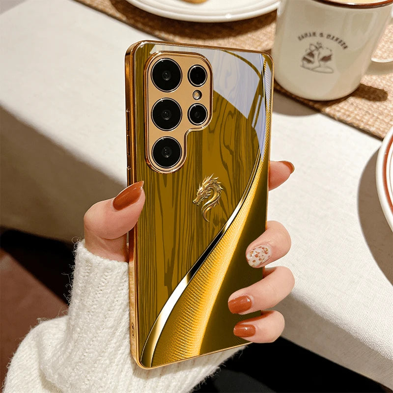 Golden galvanized phone case featuring a dragon design from Corporación Turística, with intricate dragon artwork on the surface.