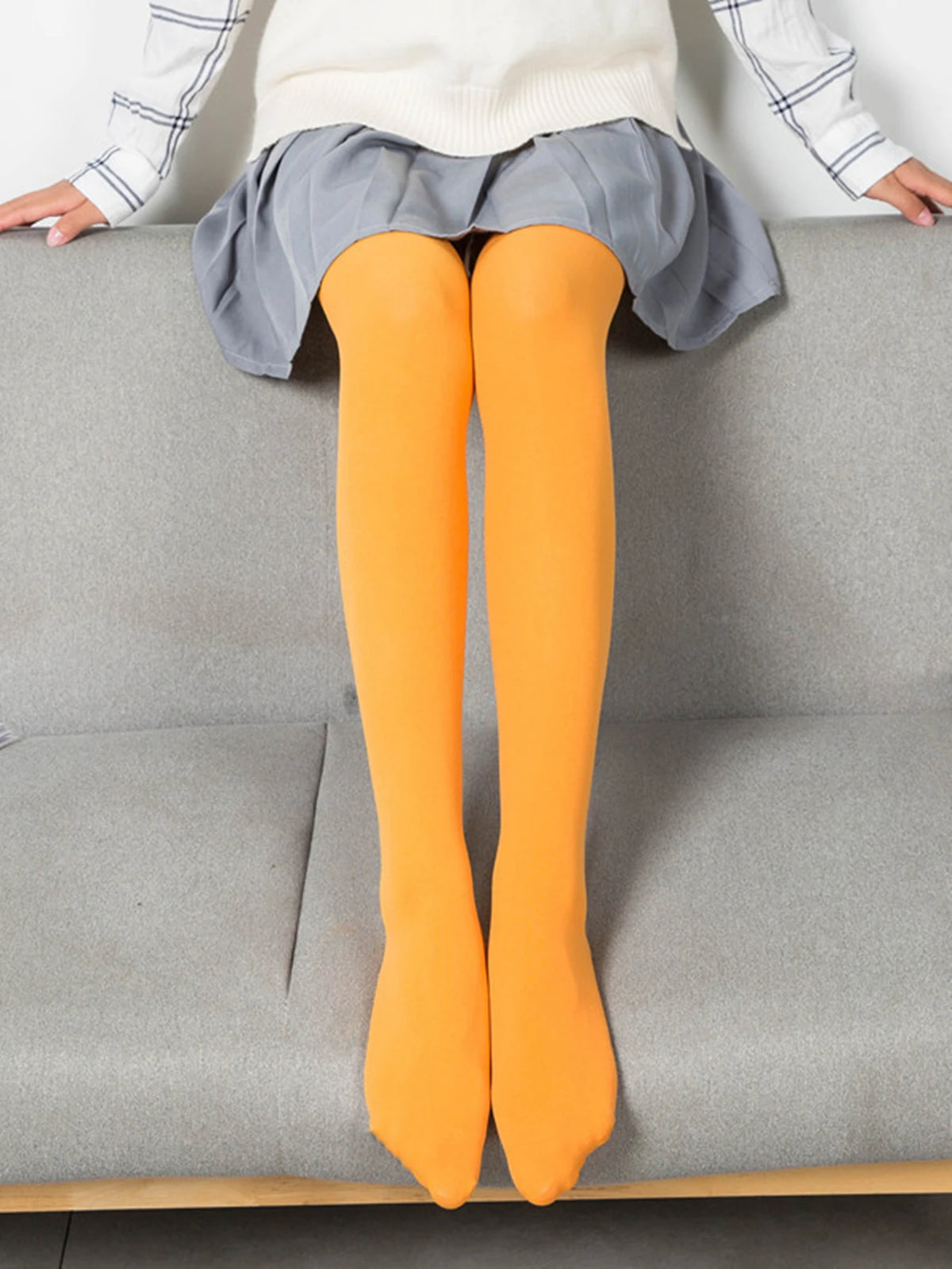 High-elasticity women's tights in vibrant pastel colors, 80D, from Corporación Turística, showcasing the smooth fabric and fit.