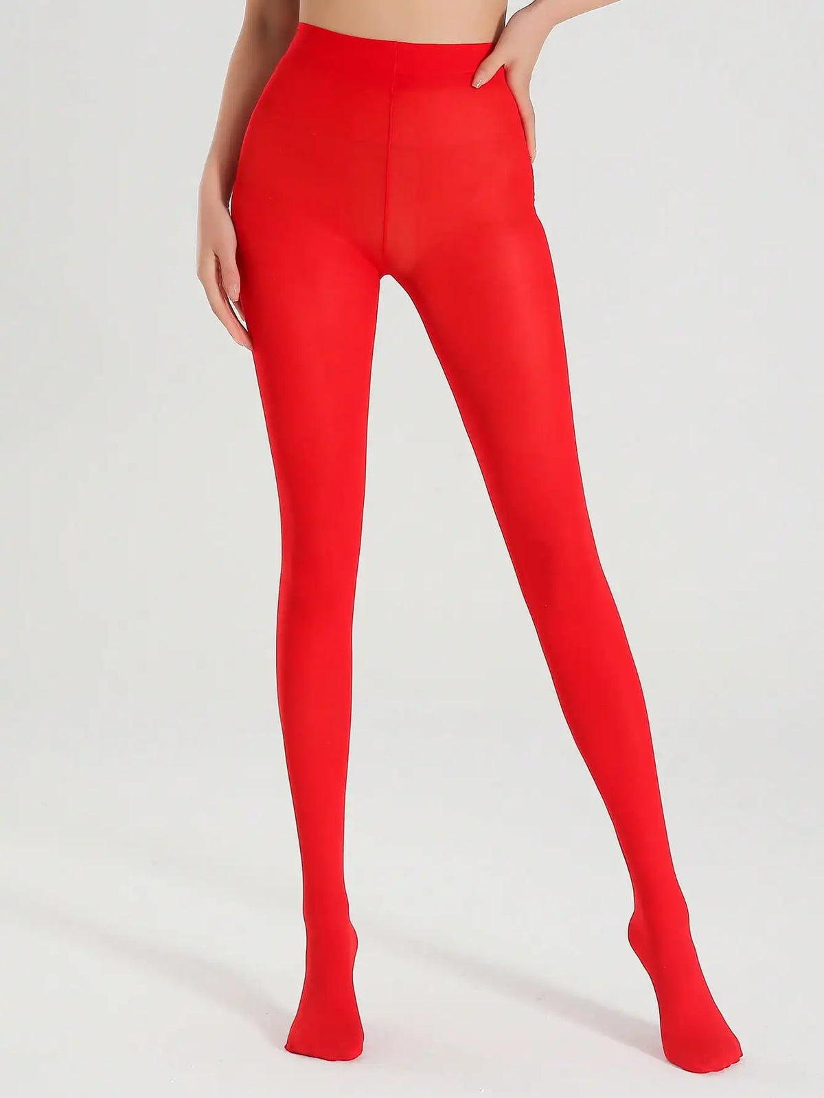 Pair of opaque red ultra-elastic nylon pantyhose from Corporación Turística, shown on a model's legs.