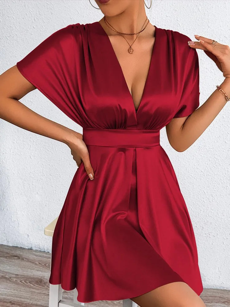Elegant sexy dress with V-neckline and low waist from Corporación Turística, featuring smooth fabric and stylish design.