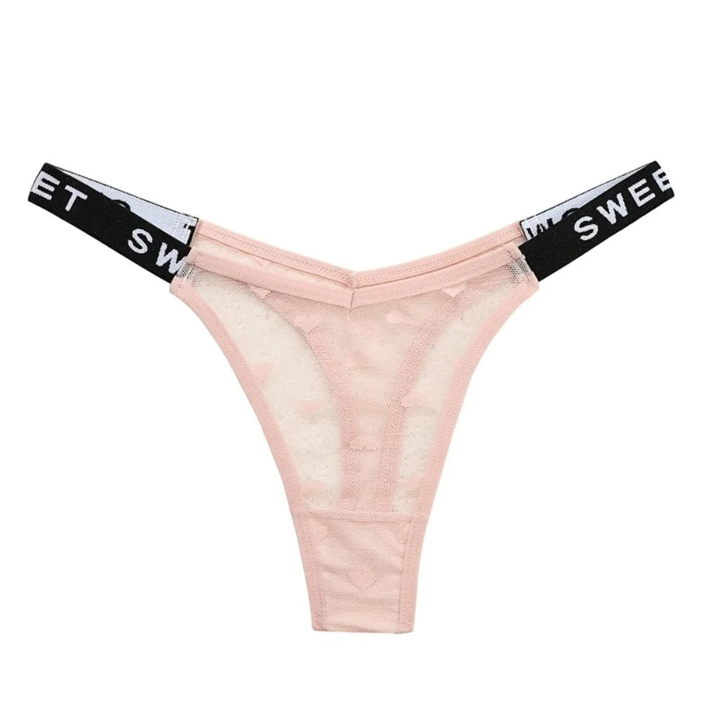 Cotton thong underwear with heart mesh design, seamless fit, by Corporación Turística, shown in close-up image.