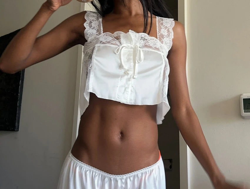 Two-piece top and pants set from Corporación Turística featuring lace details, stylish and comfortable for casual wear.