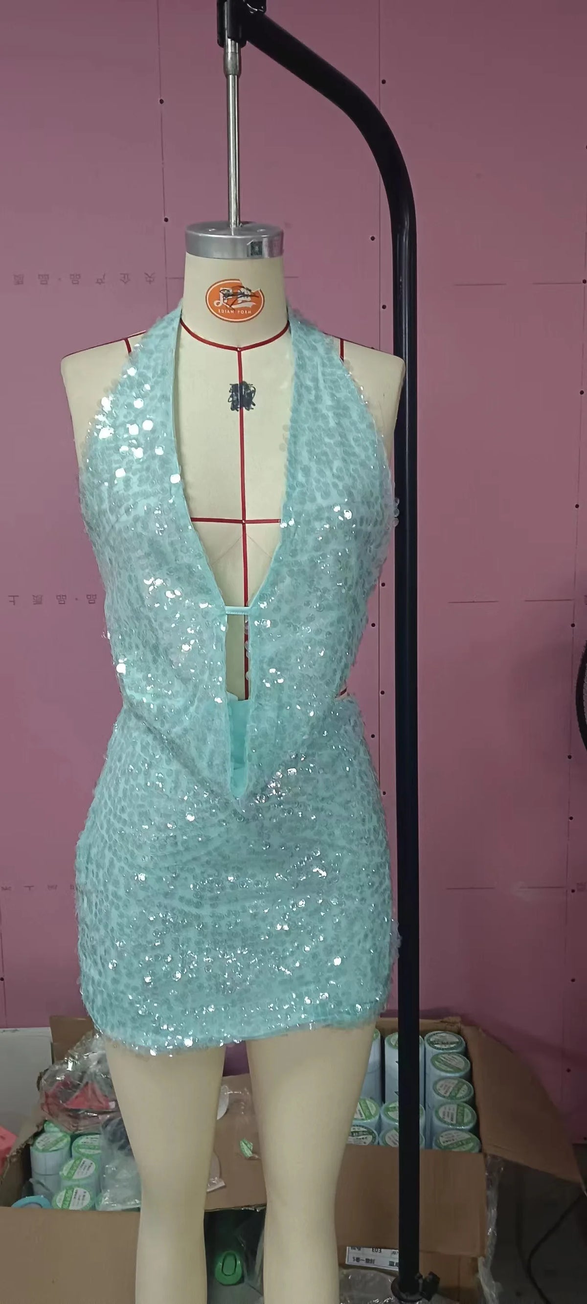 Seamless two-piece sexy sequin crop top and skirt set by Corporación Turística, with shimmering metallic finish and sleeveless design.