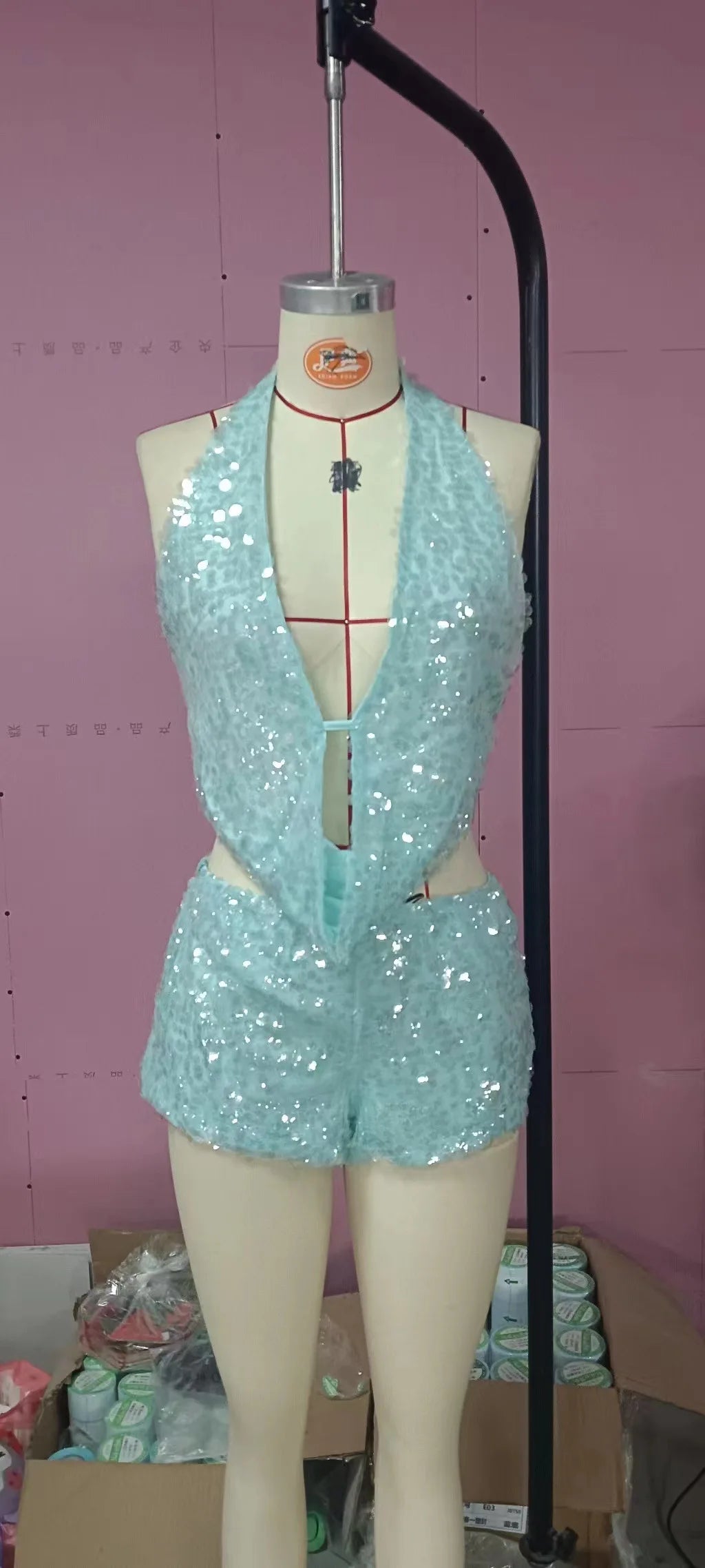 Two-piece sexy sequin set including sleeveless top and matching bottoms, featuring shiny metallic embellishments.