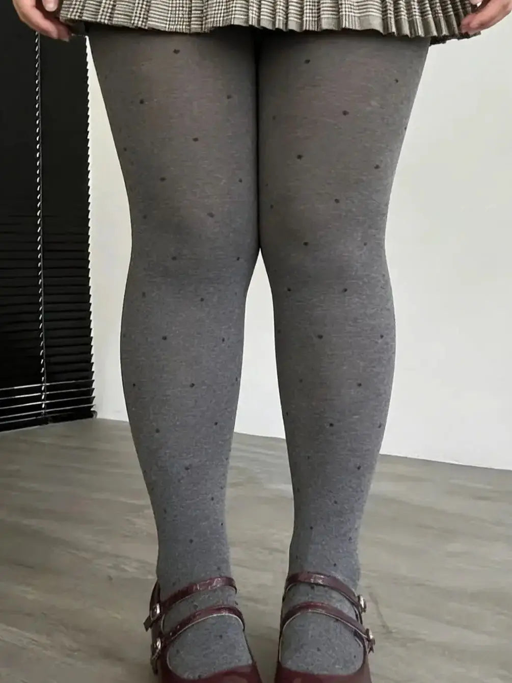 Gray vintage knit tights with small polka dot pattern from Corporación Turística, showing close-up of textured fabric and design details.