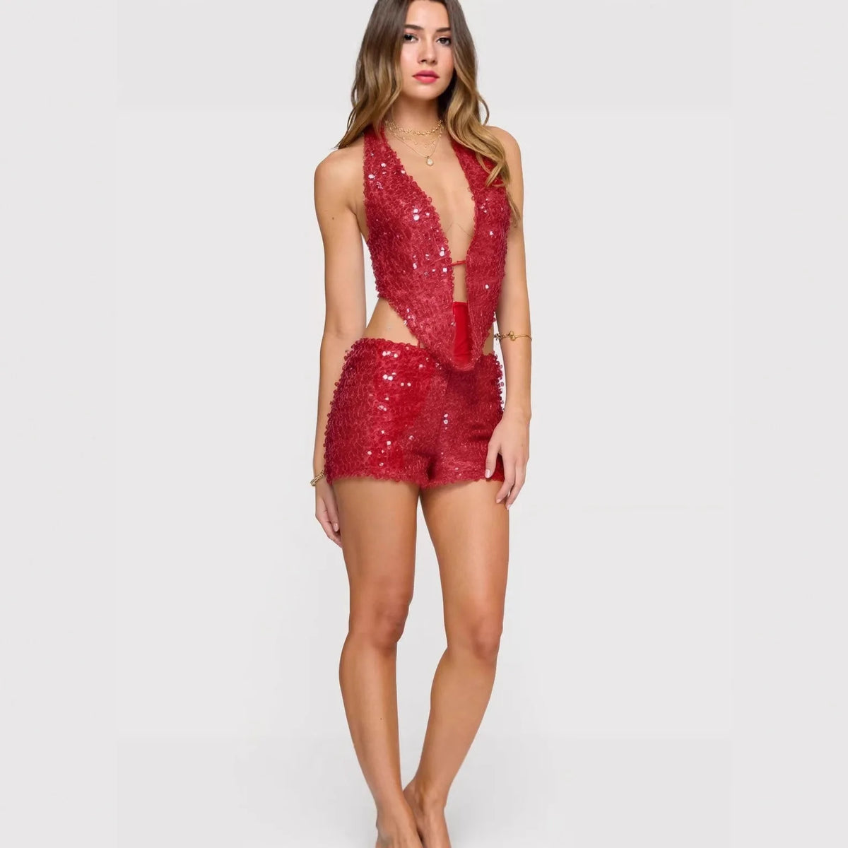 Seamless two-piece sequin crop top and skirt set by Corporación Turística, sleeveless with shiny silver embellishments.