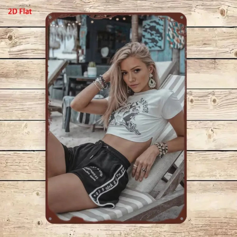 Metallic 2D sign featuring a stylish woman design by Corporación Turística, showcasing sleek metal craftsmanship and artistic detail.