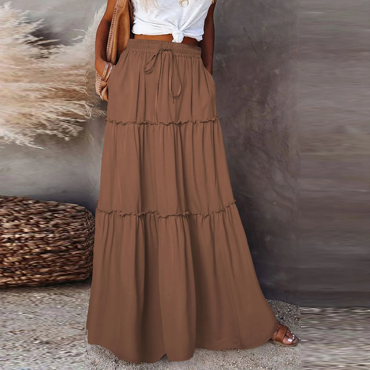 Long solid-colored women's skirt with elastic waistband, featuring flowing fabric and stylish design from Corporación Turística.