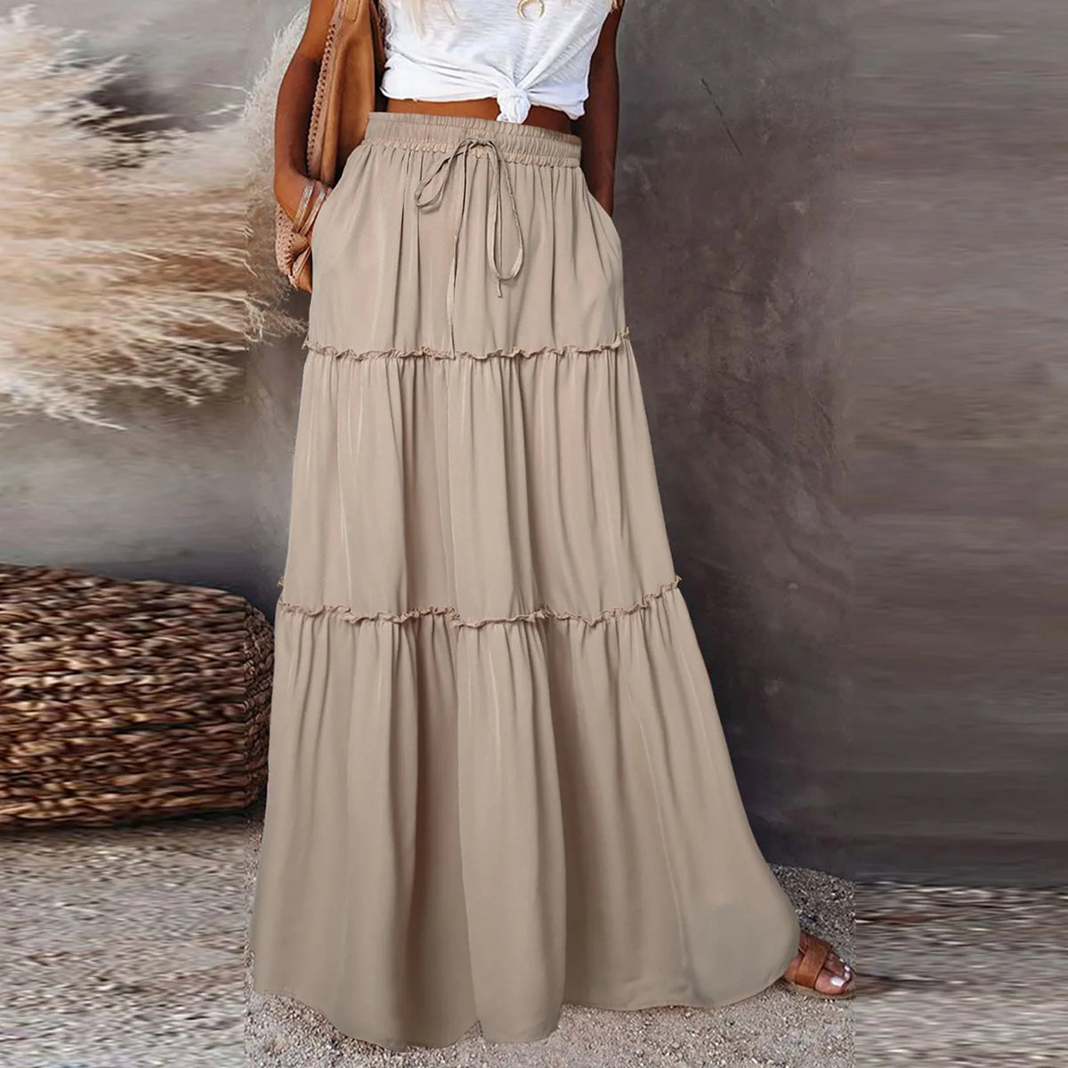 Long women's skirt with elastic waistband in solid color, featuring a flowy design by Corporación Turística.