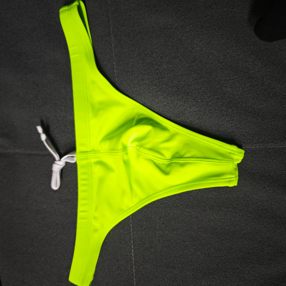 Colorful variety of wholesale 2026 swimwear styles by Corporación Turística, featuring different cuts and vibrant designs.