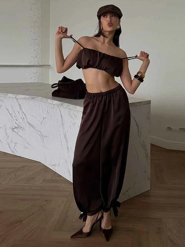 Elegant women's brown two-piece set by Chin.Sweety with pleated top and elastic pants, perfect for festive occasions.