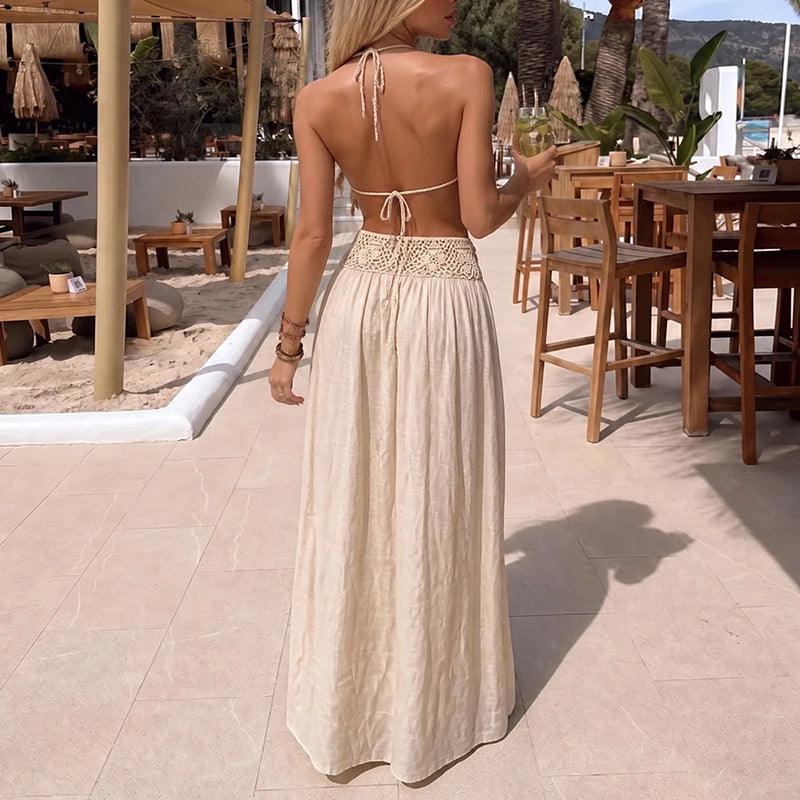 White 2-piece sexy halter neck and backless outfit by Corporación Turística, featuring a fitted design and stylish cutouts.