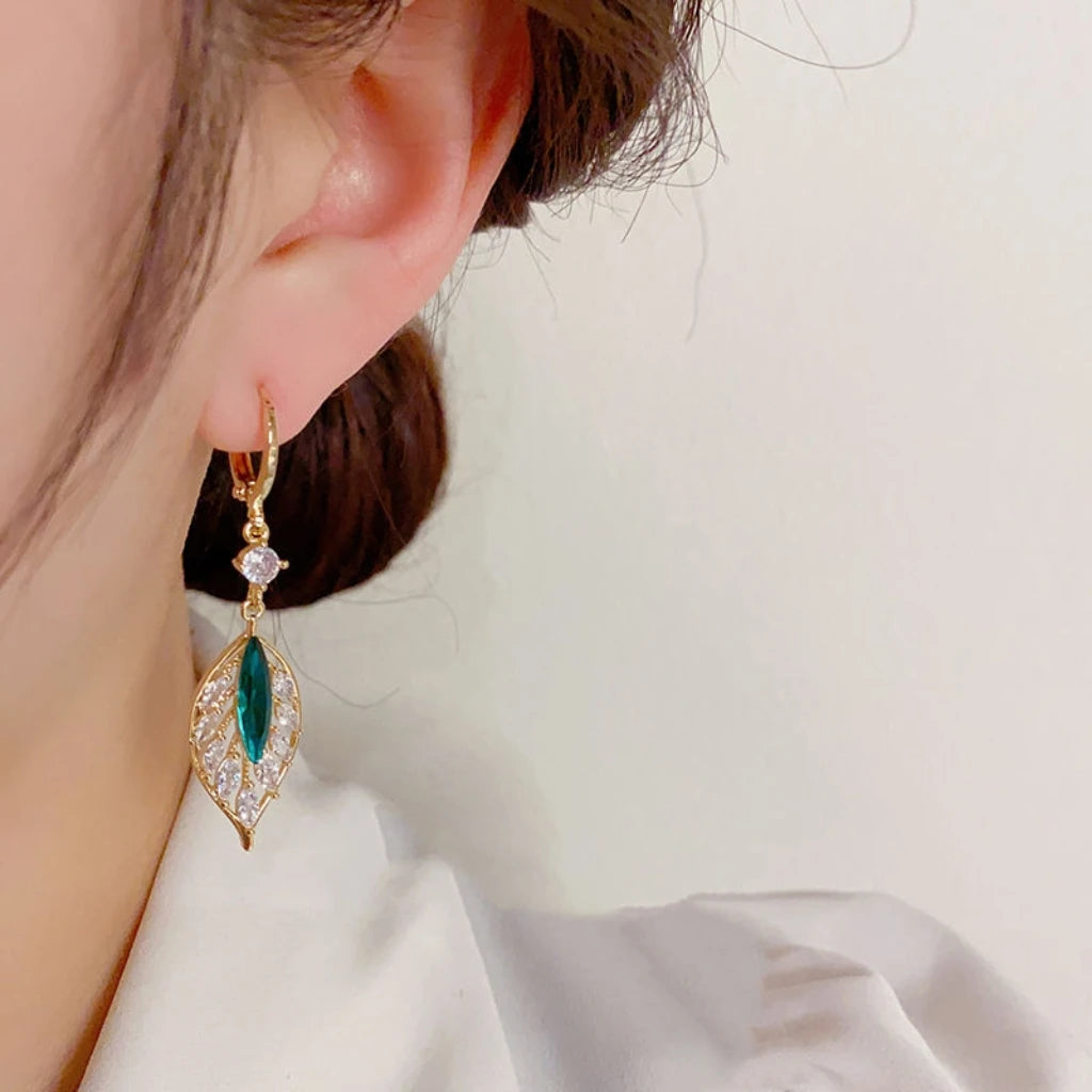Green zircon leaf drop earrings for women, featuring pendant design with black accents, from Corporación Turística.