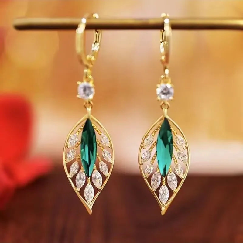 Green cubic zirconia leaf drop earrings for women, featuring elegant pendant design with black accents from Corporación Turística.
