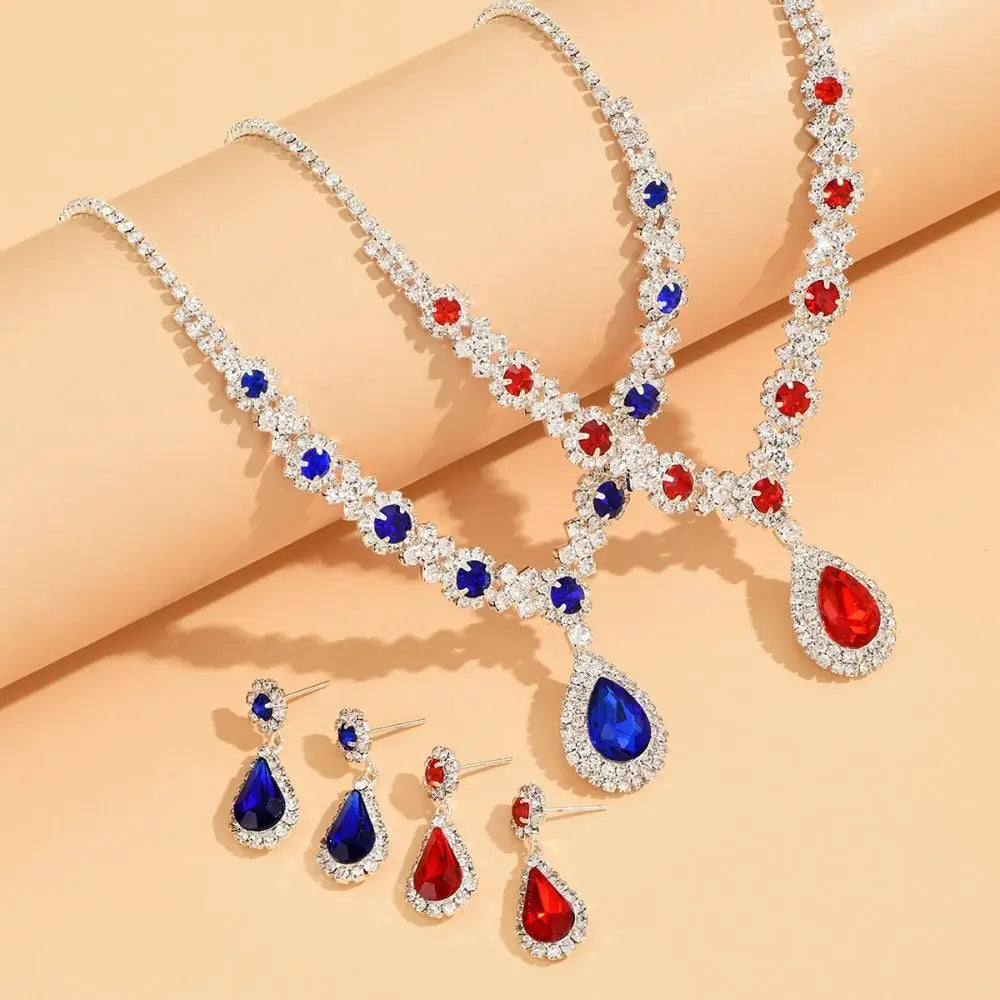 Elegant jewelry set with crystal pendant necklace and matching earrings by Corporación Turística, featuring sparkling glass accents.