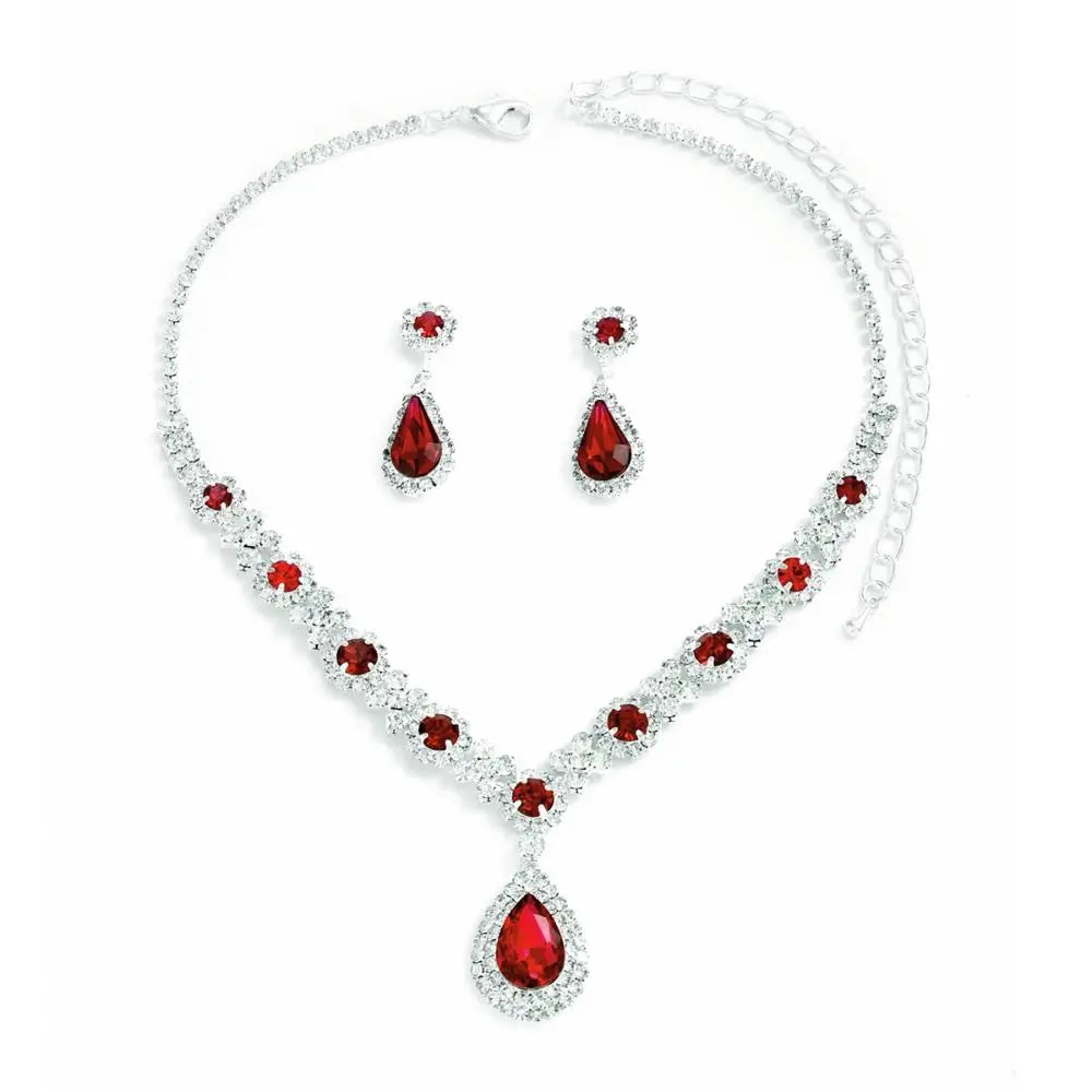 Elegant crystal jewelry set featuring matching earrings and necklace with sparkling crystal details, designed by Corporación Turística.