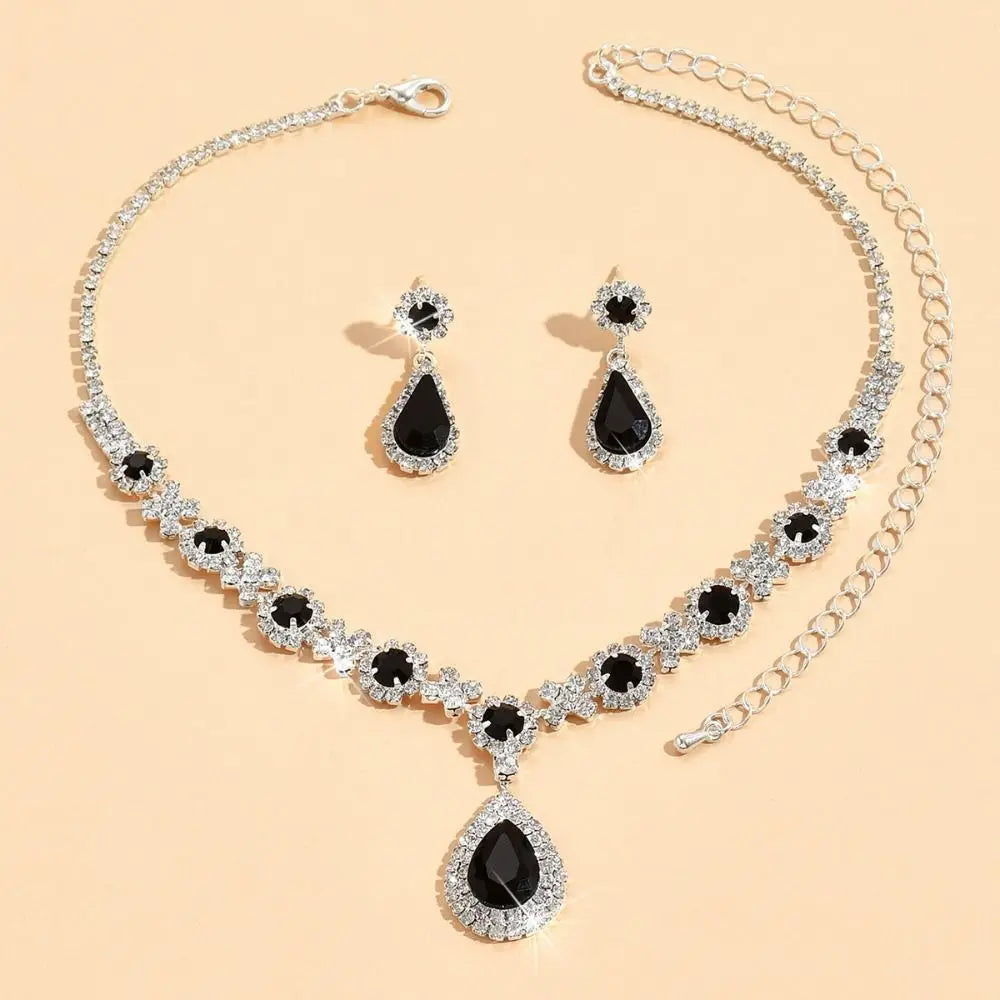 Elegant jewelry set with crystal pendant necklace and matching earrings by Corporación Turística, featuring sparkling crystal details.
