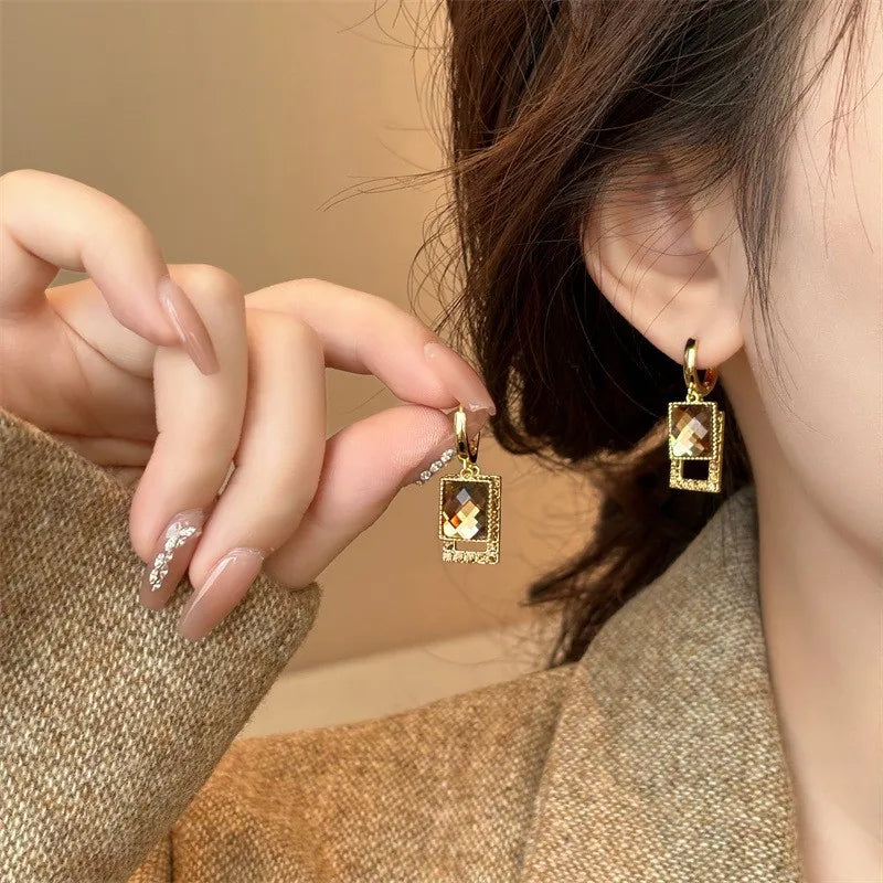 Silver 925 needle drop earrings with cubic zirconia by Corporación Turística, featuring elegant black gemstone drops.
