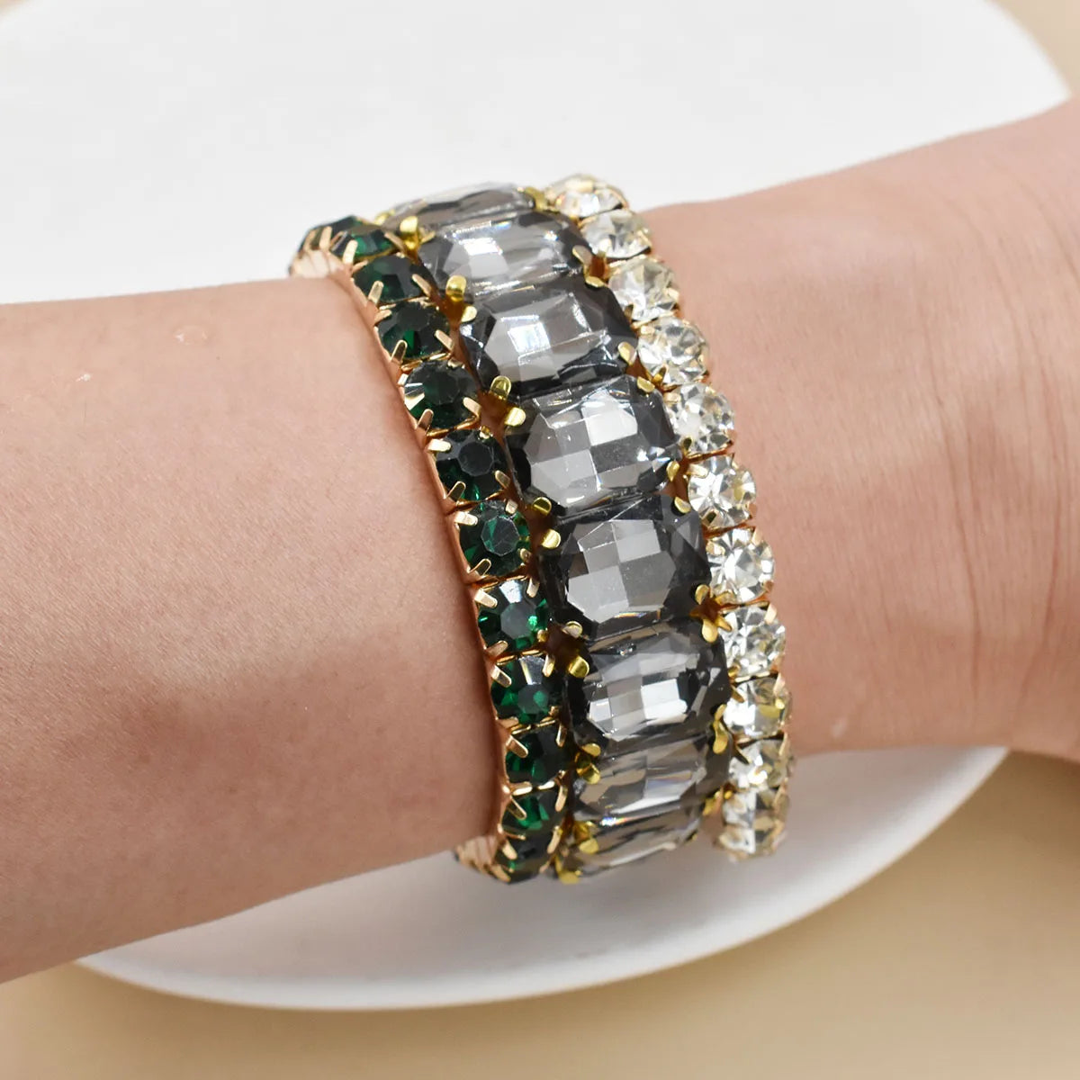 Three new women's crystal bracelets with geometric design from Corporación Turística, featuring clear, sparkling crystal beads.