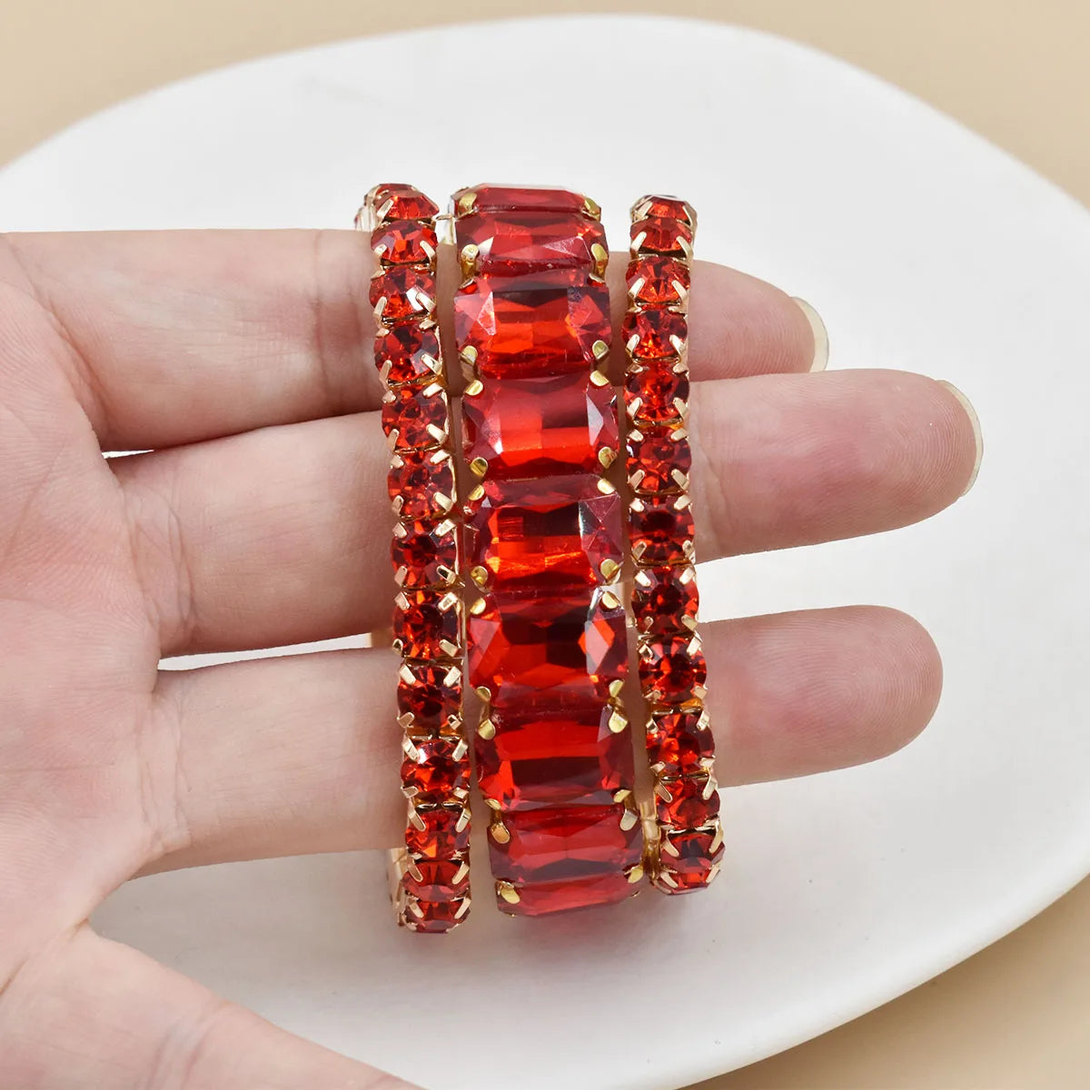 Three new women's crystal bracelets with geometric designs, featuring transparent and colorful beads, by Corporación Turística.