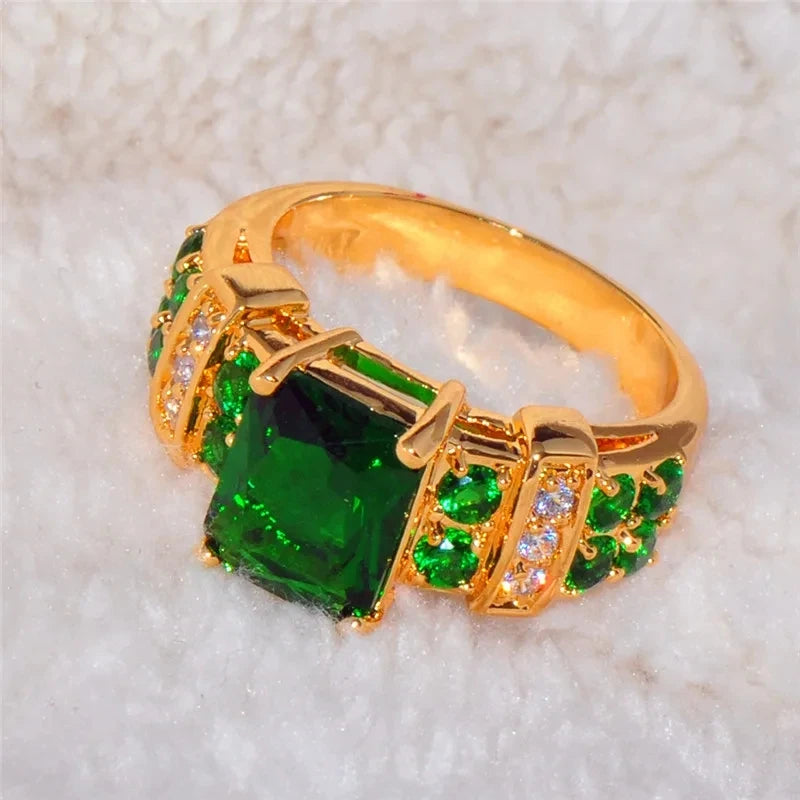 Green fashion crystal ring with a wedding band design, featuring a sleek silver-tone finish and a sparkling green crystal centerpiece.