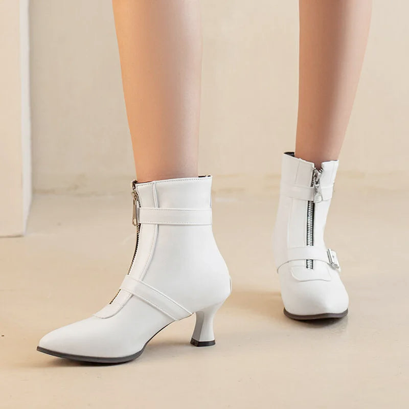 White women's chunky heel ankle boots by Corporación Turística, stylish winter shoes with thick heels and cozy design.