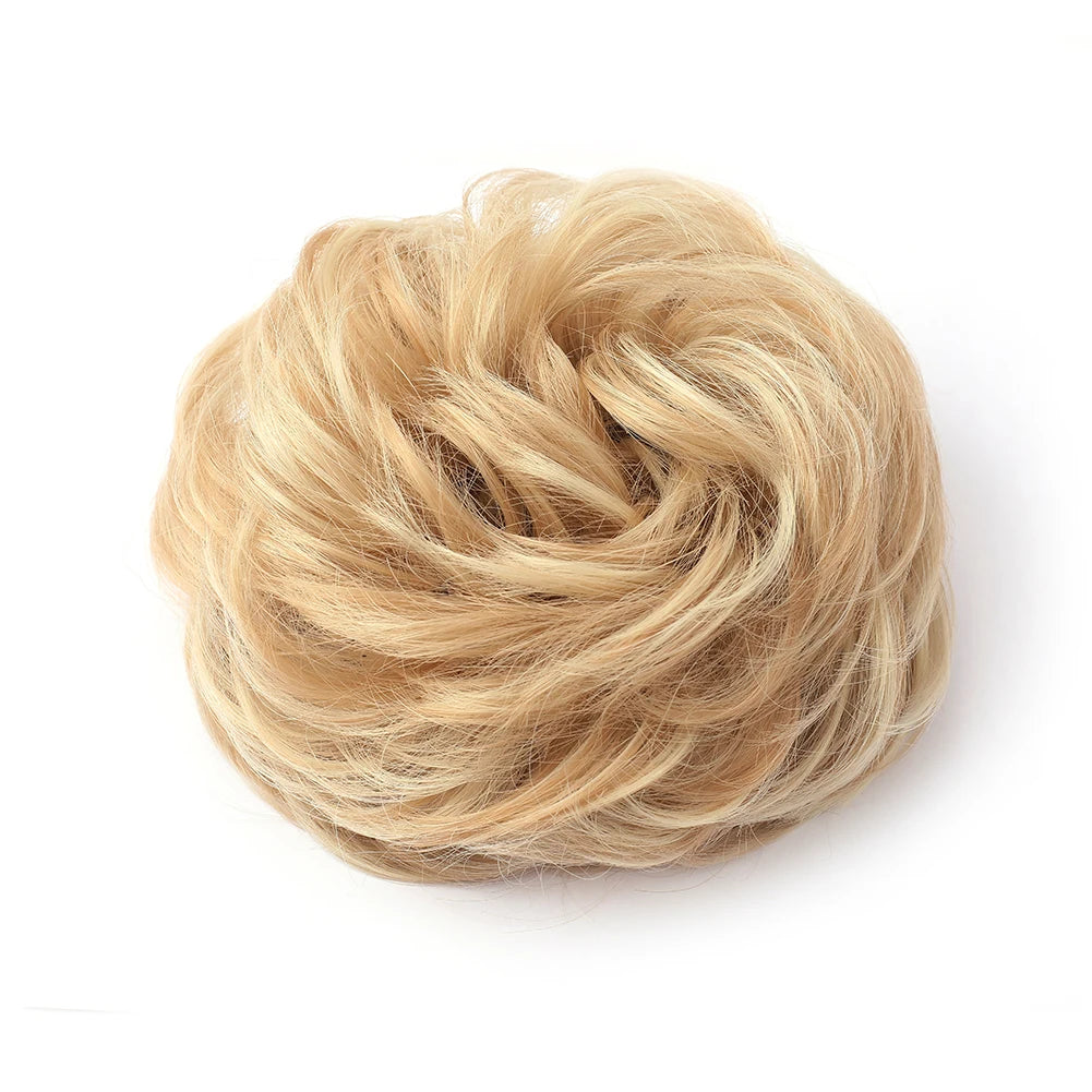 Large messy bun hairstyle featuring wavy, curly hair with a natural, tousled look, created by Corporación Turística.