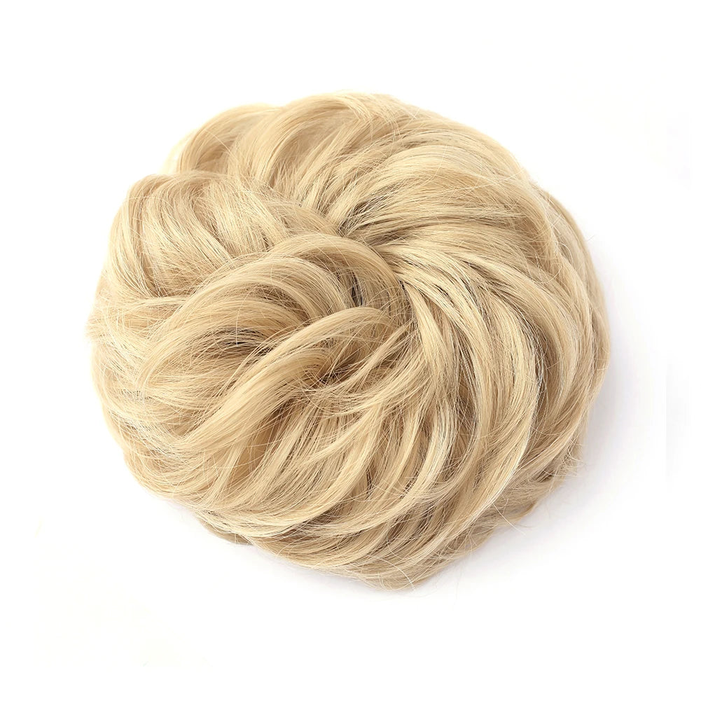 Large messy bun hairstyle with wavy and curly hair, styled by Corporación Turística, showcasing a loose, tousled hairpiece.
