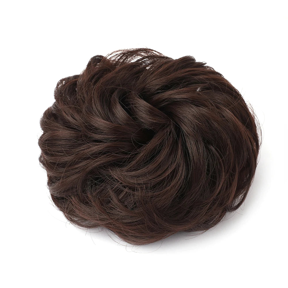 Large messy bun hairstyle with wavy and curly hair, featuring a natural, tousled look, perfect for casual or stylish occasions.