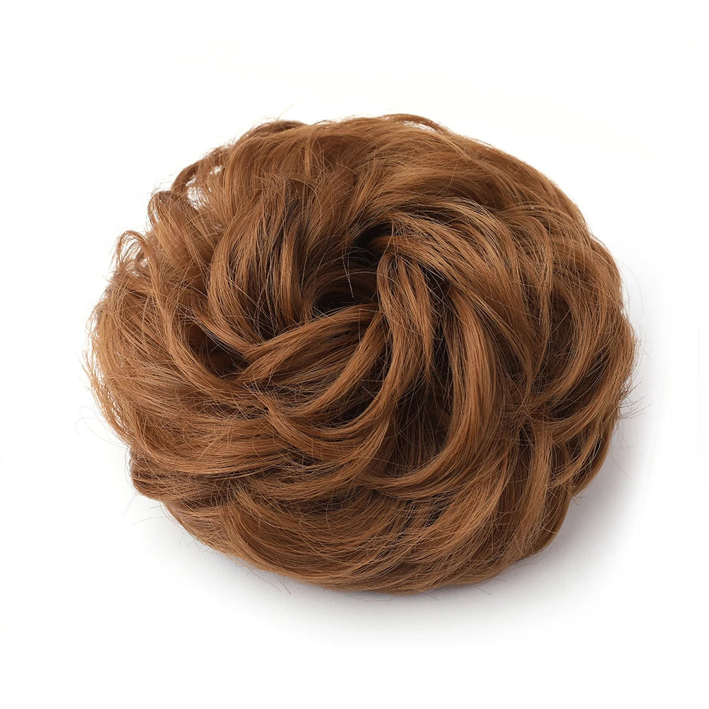 Large messy bun hairstyle with wavy, curly hair piece from Corporación Turística, showcasing a tousled, voluminous hairdo.
