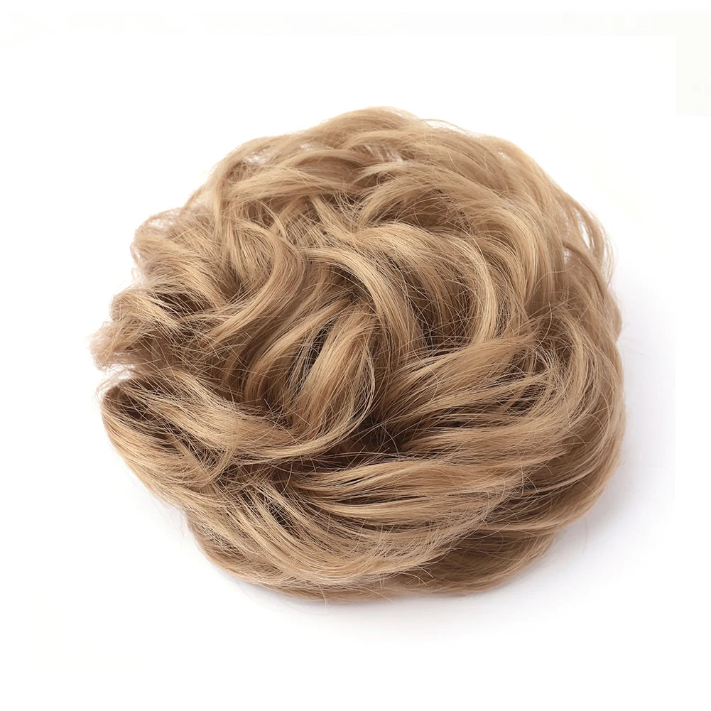 Large messy bun hairstyle with wavy, curled hair, featuring a natural, tousled look by Corporación Turística.