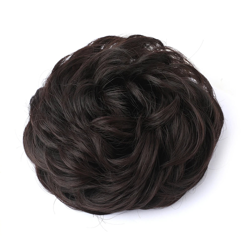 Large messy bun hairstyle with wavy and curly hair piece by Corporación Turística, showcasing a stylish, tousled hair look.