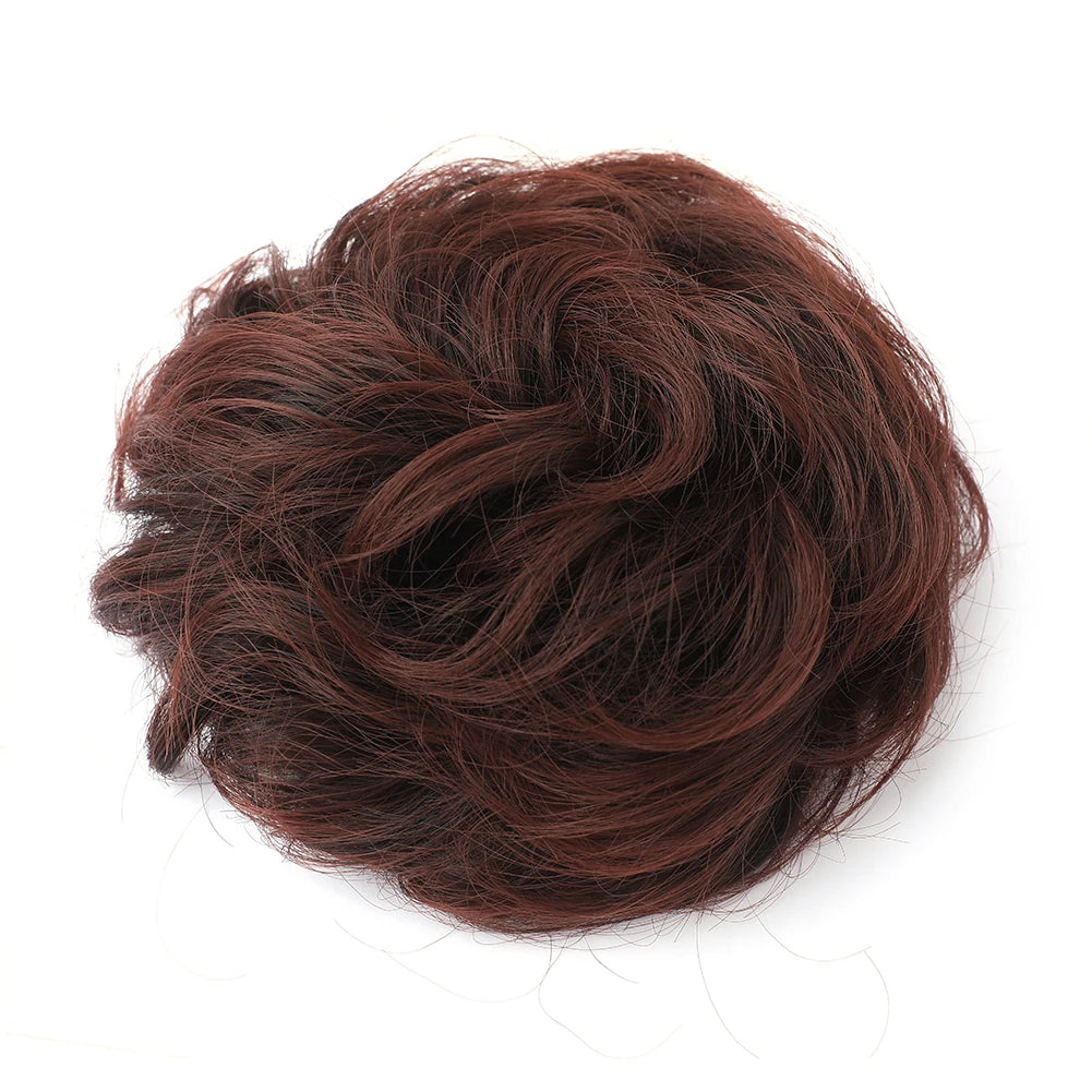 Large messy bun hairstyle with wavy and curly hair piece, created by Corporación Turística.